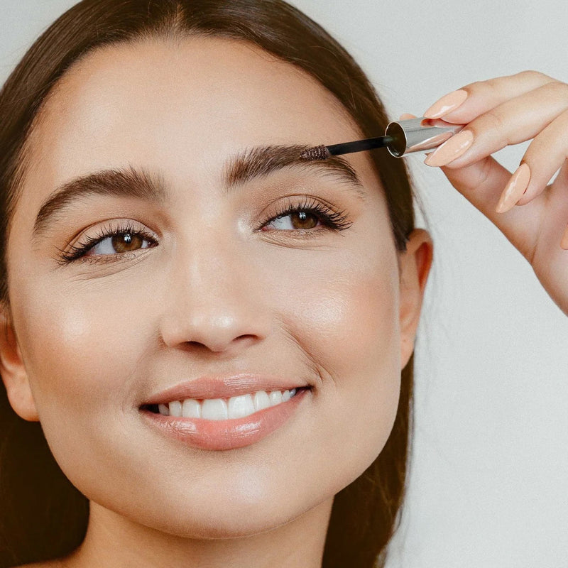 Woman applying brow gel from The Green Kiss